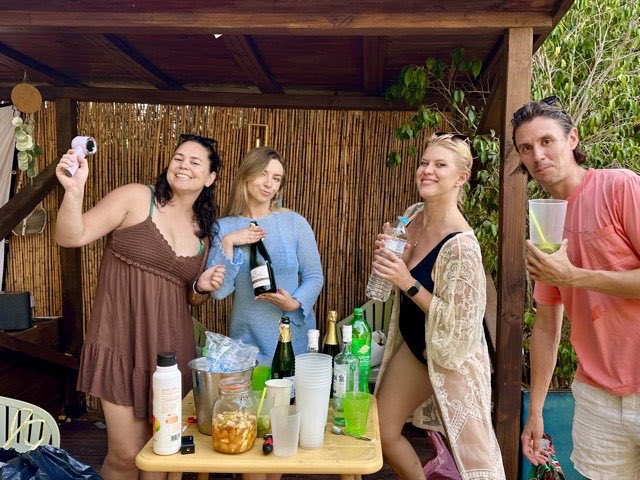 Members mixing drinks at the bar by the pool